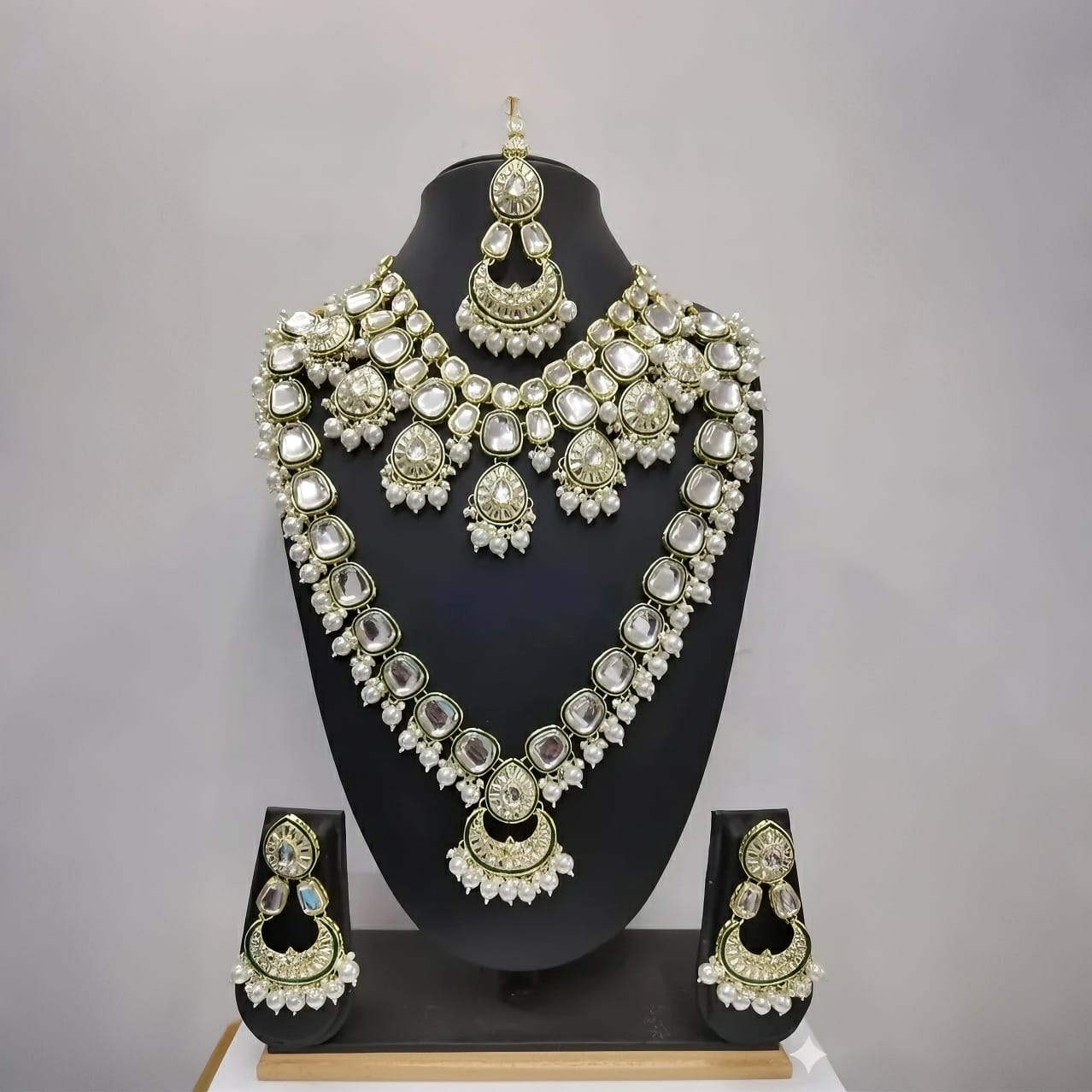 Luxurious long and short layered necklace design with matching earrings and maang tikka